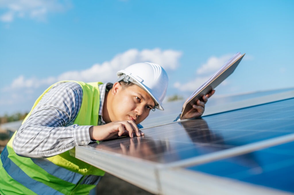 young asian technician man checking operation photovoltaic solar